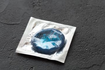 concept male contraception condom on dark background