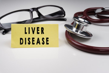 Sticky notes written with LIVER DISEASE and stethoscope on white background. Medical Concept.