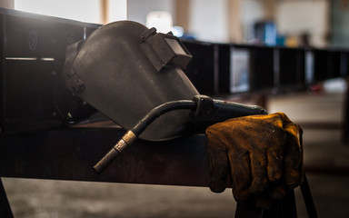 Fototapeta Welding equipment, welding gloves, welding helmets in the factory. obraz