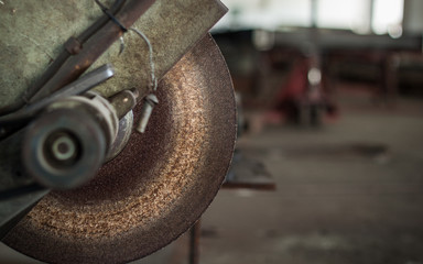 Steel cutter blade with a blurred background.