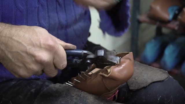 Shoemaker is Making Shoes in His Atelier