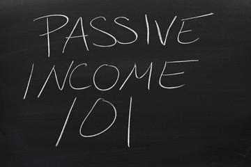 The words "Passive Income 101" on a blackboard in chalk