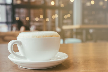 Cup of Cappuccino Coffee with foam froth cover on top. Cafe shop