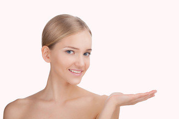 Beauty Woman face Portrait. Skin Care Concept Isolated on a pink background