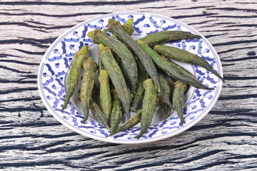 Crispy Okra dried seasoning on Thai pattern dish.