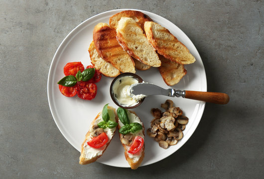 Tasty bruschetta on plate, top view