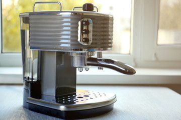 Modern coffee machine on kitchen table