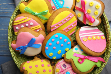 Wicker basket with tasty Easter cookies, closeup