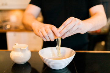 Cracking eggs in a bowl