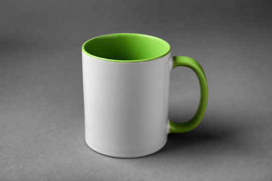Blank ceramic cup on grey background