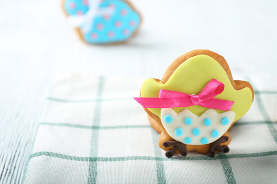 Creative chicken shape Easter cookie on napkin, closeup