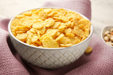 Bowl with cornflakes on napkin, closeup