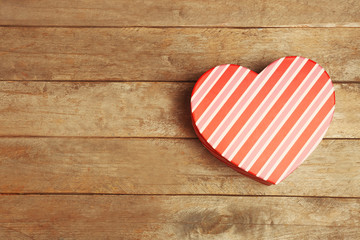 Heart shaped gift box on wooden background