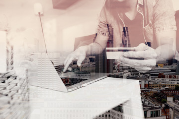 double exposure of hipster hand using laptop compter,holding cra