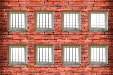 windows with bars of iron on red old  brick wall
