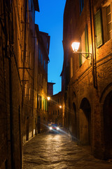 alley in Siena, Italy, at night