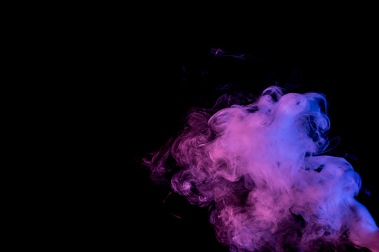 Abstract smoke Weipa. Personal vaporizers fragrant steam. The concept of alternative non-nicotine smoking. Blue lilac smoke on a black background. E-cigarette. Evaporator. Taking Close-up. Vaping.