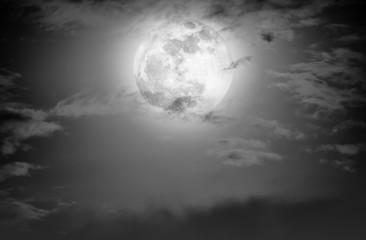 Nighttime sky with clouds and bright full moon.  Black and white