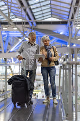 Fototapeta na wymiar Senior couple traveling airport scene