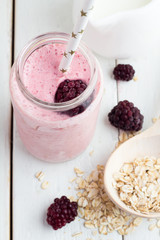 blackberry smoothie in a bottle with a straw