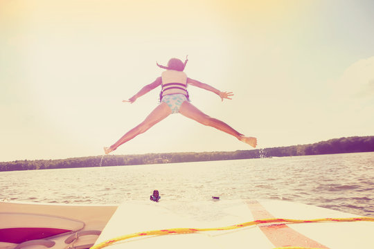 Kids Jumping Off A Boat Into The Lake. Instagram Effect.