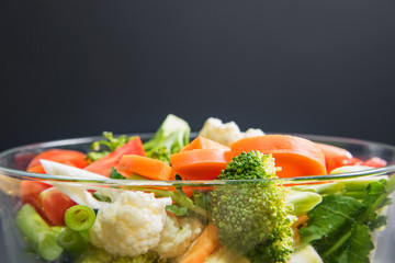healthy foods are on the table, Fresh vegetable salad in a glass