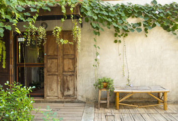 Wood door and bamboo bench with green plant
