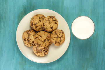 Chocolate chips cookies with glass of milk, shot from above