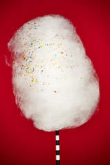 cotton candy with sprinkles on a decorative straw