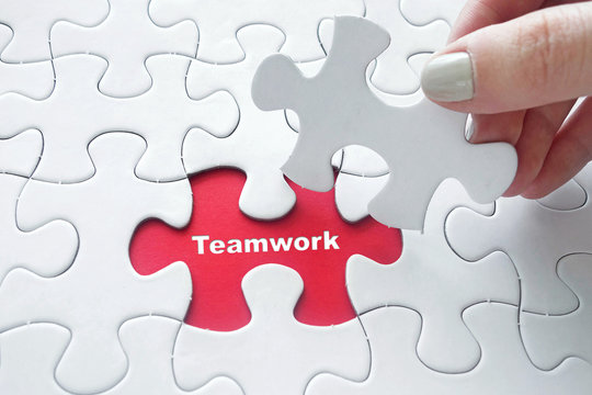 Teamwork on on jigsaw puzzle