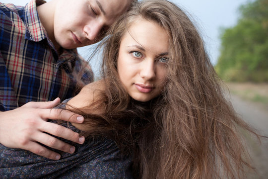 Young Man And Woman Walking In A Field