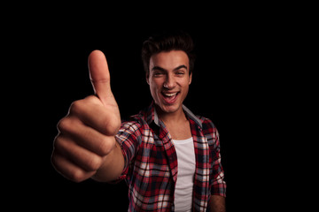 excited young casual man making the ok sign