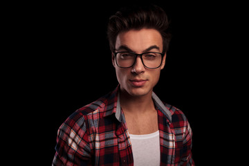 closeup of a young man in checkered shirt and glasses