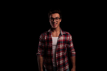 laughing young sexy man in checkered shirt and jeans