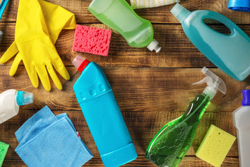 Cleaning supplies on wooden table with copy space