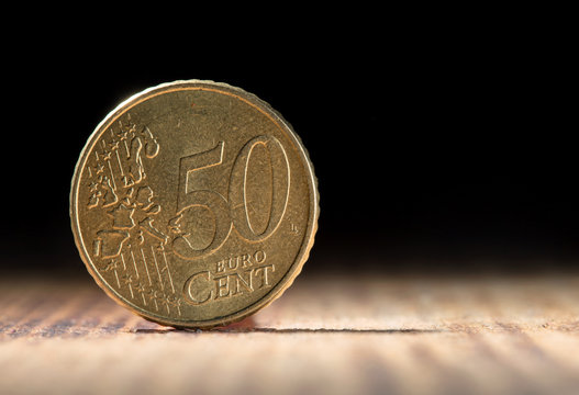 Fifty euro cents on black background with copy space