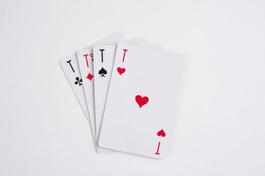 A winning poker hand of four aces playing cards suits on white