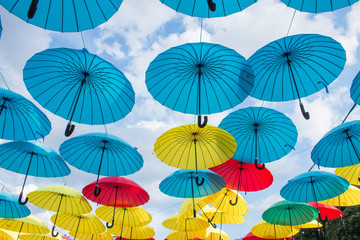 Fototapeta na wymiar Hanging opened colored umbrellas