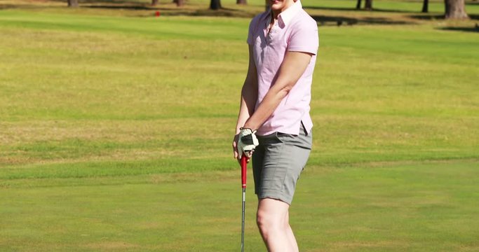 Female golf player playing golf at golf course 4k