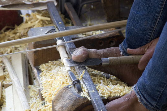 Handwerker drechselt mit den F&uuml;&szlig;en