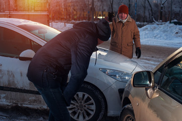 Male drivers on city street after car crash