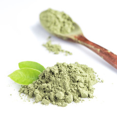 powder green tea with green tea leaf and spoon isolated on white