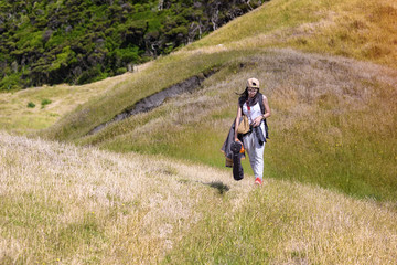 woman hiker tourist walking trekking alone in hillsside