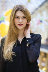 Beautiful blonde girl in black blouse