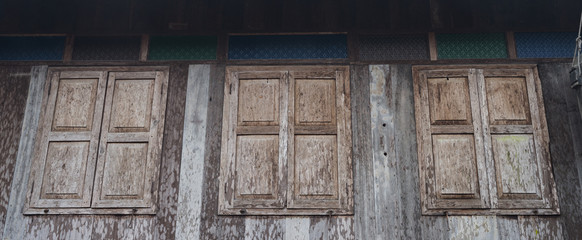 Vintage closed windows on wooden wall