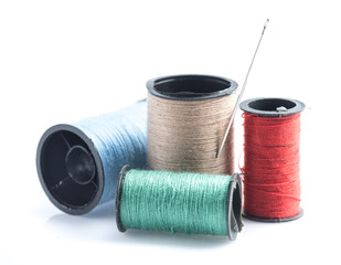 Colorful sewing Threads with needle isolated on white background