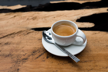 Espresso in white mug on wood table