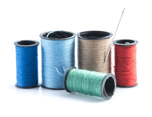 Colorful sewing Threads with needle isolated on white background