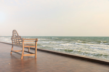 Chair in front of the see under the blue sky