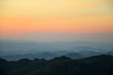 Sunset through the clouds with silhouetted mountians